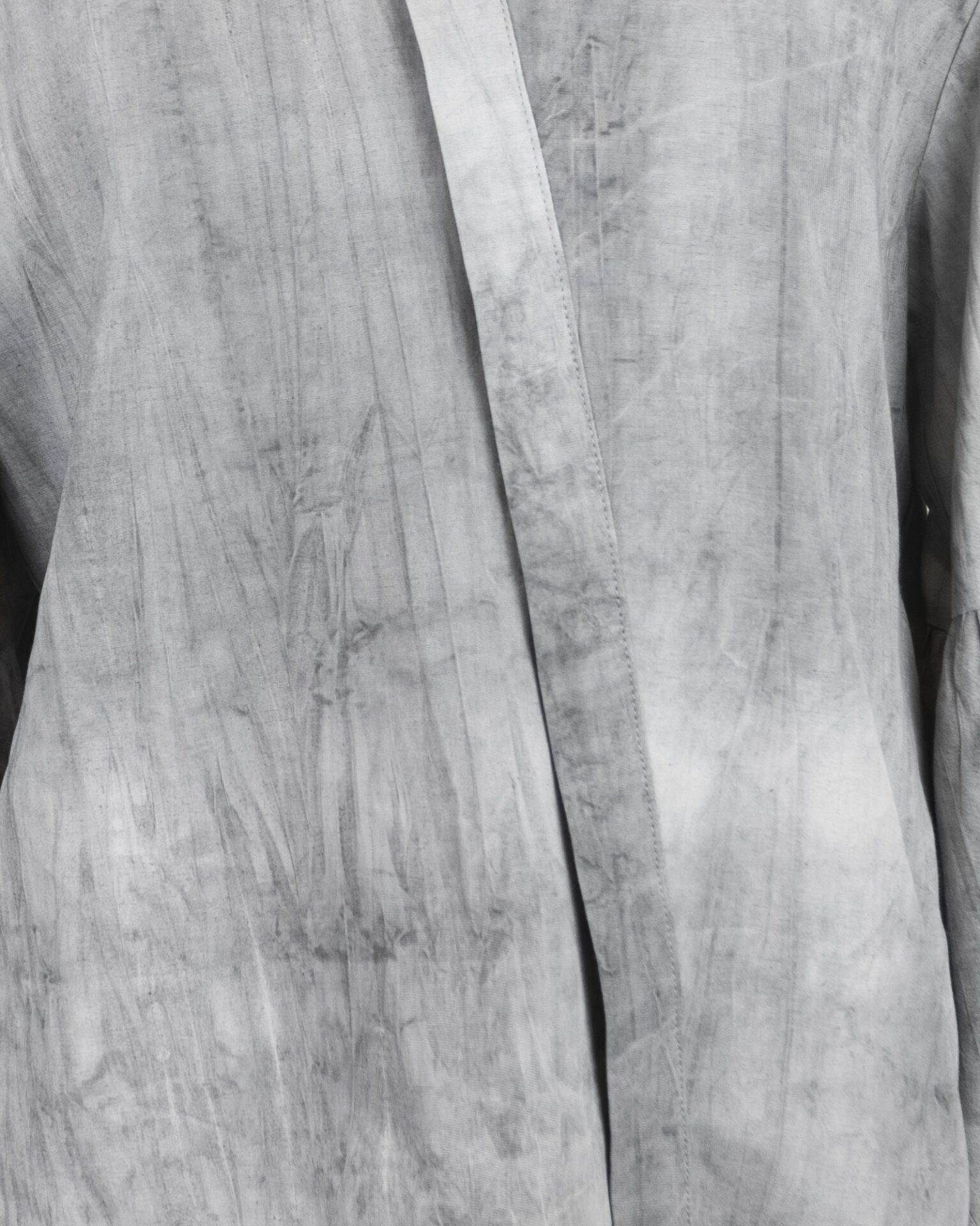 Relaxed fit shirt with stand collar, press stud asymmetrical fastening and double gathered bishop sleeves.