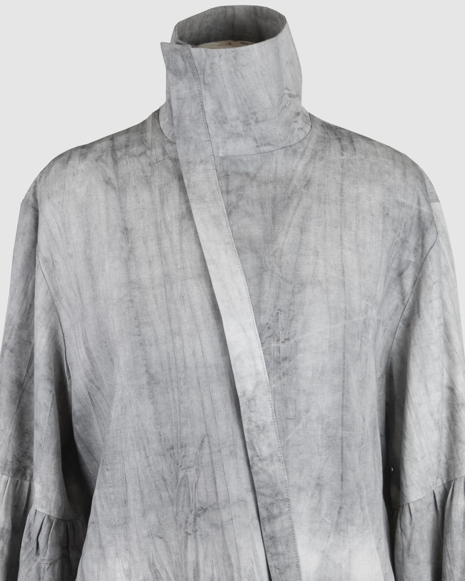 Relaxed fit shirt with stand collar, press stud asymmetrical fastening and double gathered bishop sleeves.