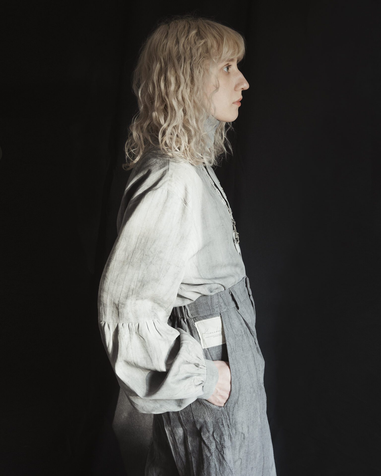 Slightly high-rise trousers featuring a front zipper, side pockets, and an elasticized back waistband for adjustable sizing.