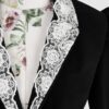Fitted, single breasted cotton velvet jacket with a narrow peak lapel collar, released tucks at the waist, side seam pockets, and a softly pointed front hem.