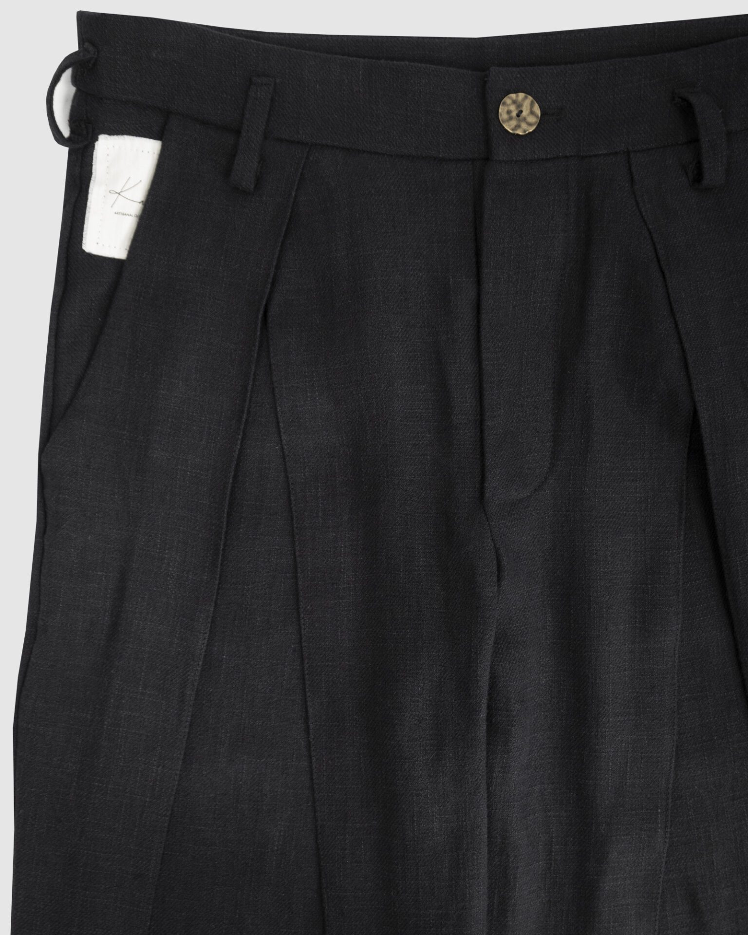 Trousers with overlapping pleats