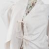 Cotton satin fitted blouse with a draped front and voluminous sleeves.