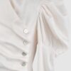 Cotton satin fitted blouse with a draped front and voluminous sleeves.