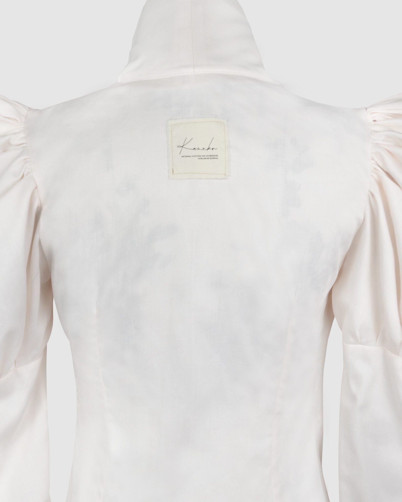 Cotton satin fitted blouse with a draped front and voluminous sleeves.