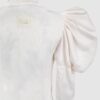Cotton satin fitted blouse with a draped front and voluminous sleeves.