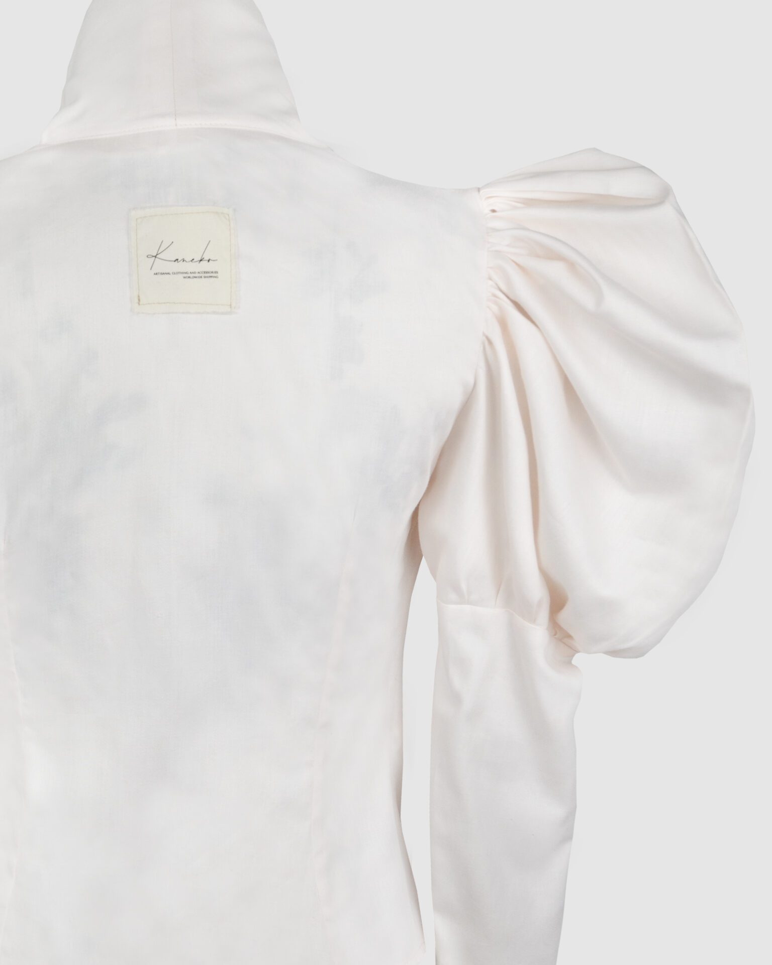 Cotton satin fitted blouse with a draped front and voluminous sleeves.