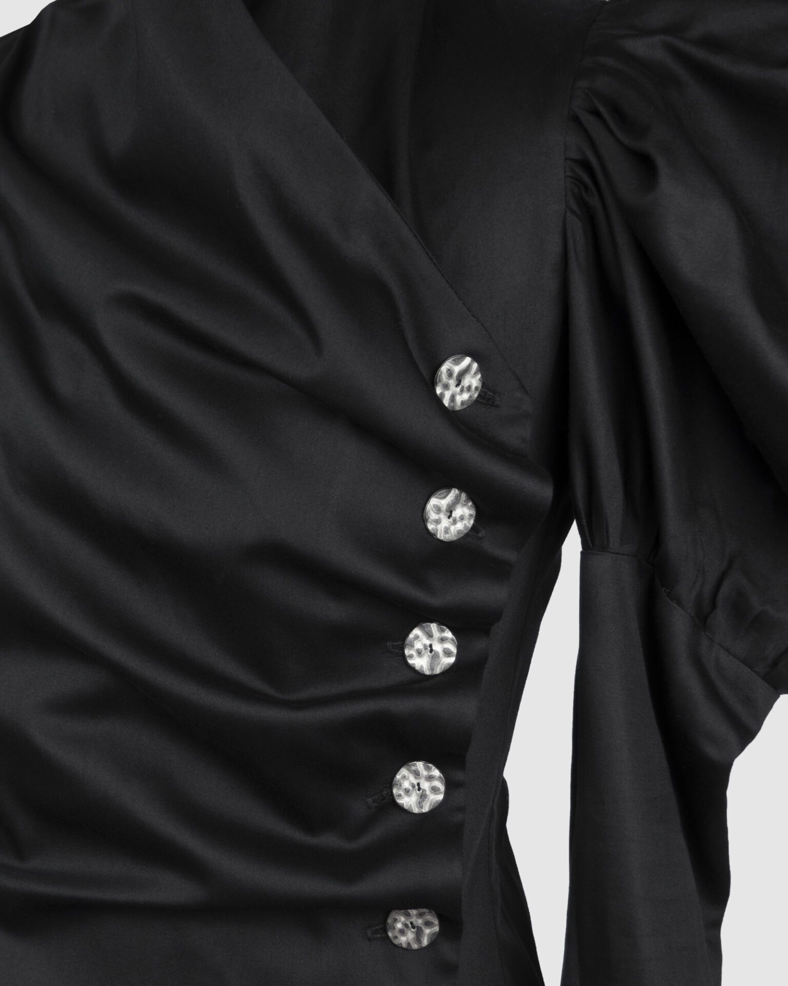 Cotton satin fitted blouse with a draped front and voluminous sleeves.