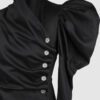 Cotton satin fitted blouse with a draped front and voluminous sleeves.