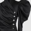 Cotton satin fitted blouse with a draped front and voluminous sleeves.