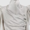 Cotton satin fitted blouse with a draped front and voluminous sleeves.