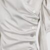 Cotton satin fitted blouse with a draped front and voluminous sleeves.