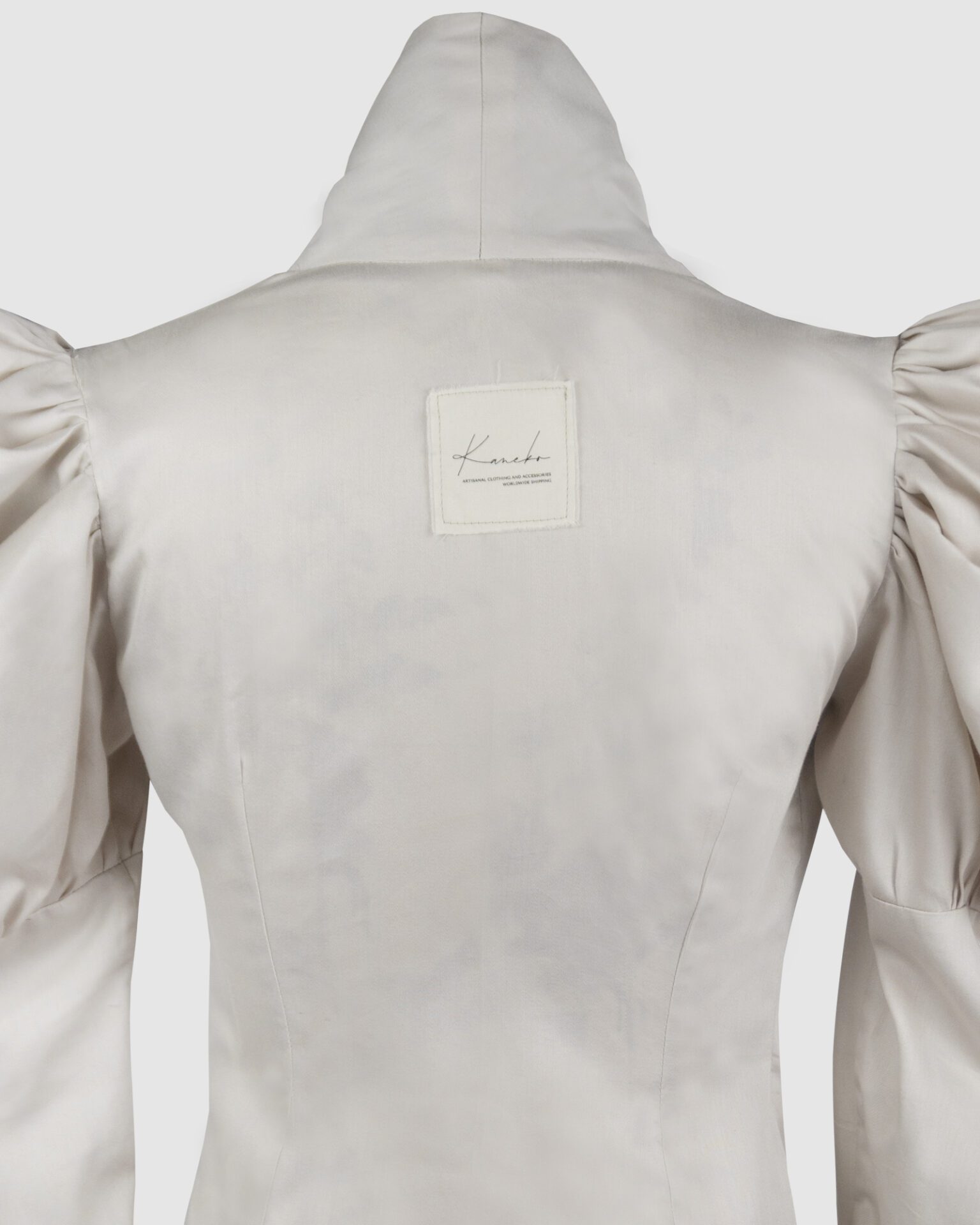 Cotton satin fitted blouse with a draped front and voluminous sleeves.