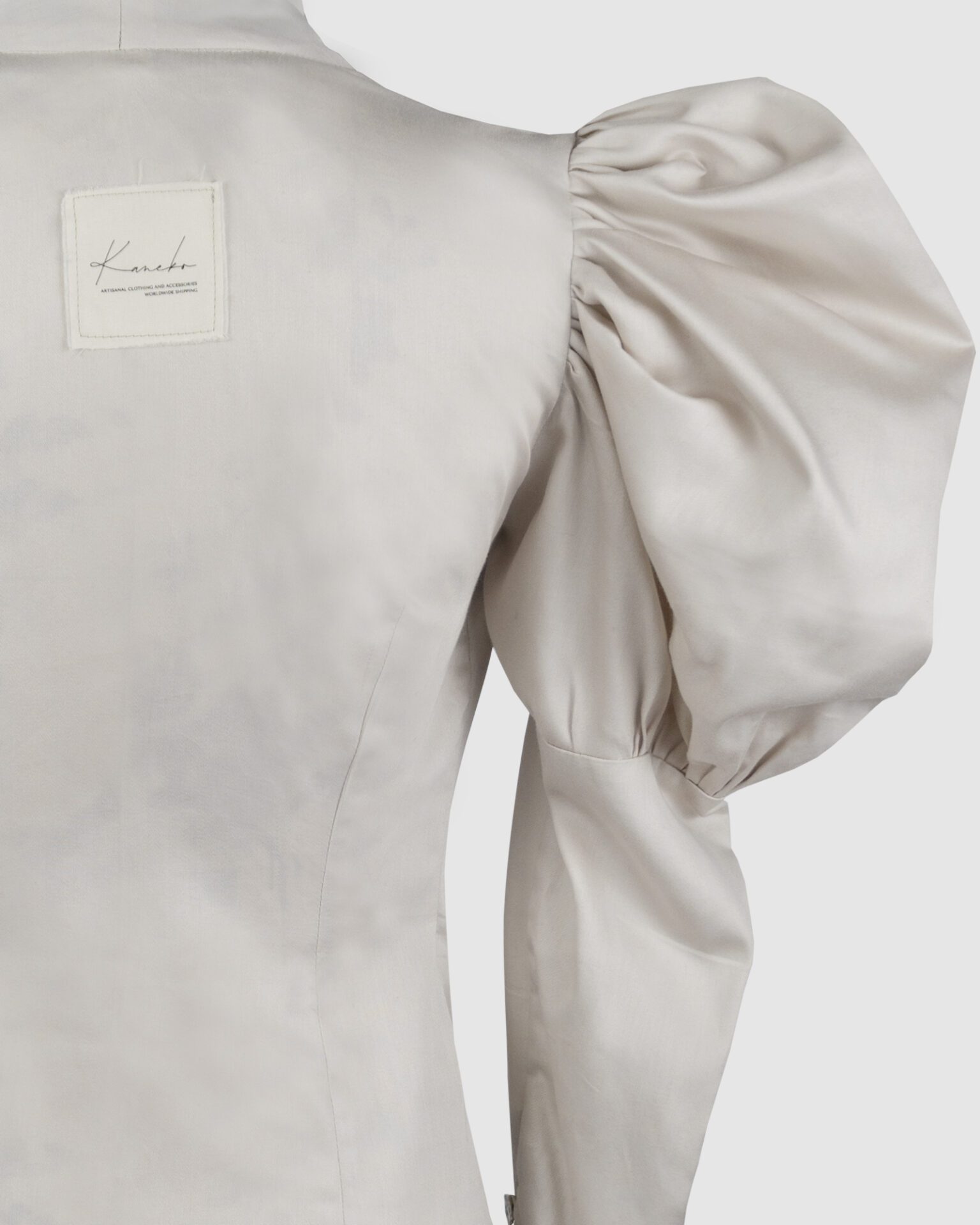 Cotton satin fitted blouse with a draped front and voluminous sleeves.