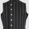 The long, fitted vest features a stand collar, a welt breast pocket, and pockets with pointed flaps.