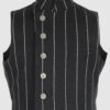 The long, fitted vest features a stand collar, a welt breast pocket, and pockets with pointed flaps.