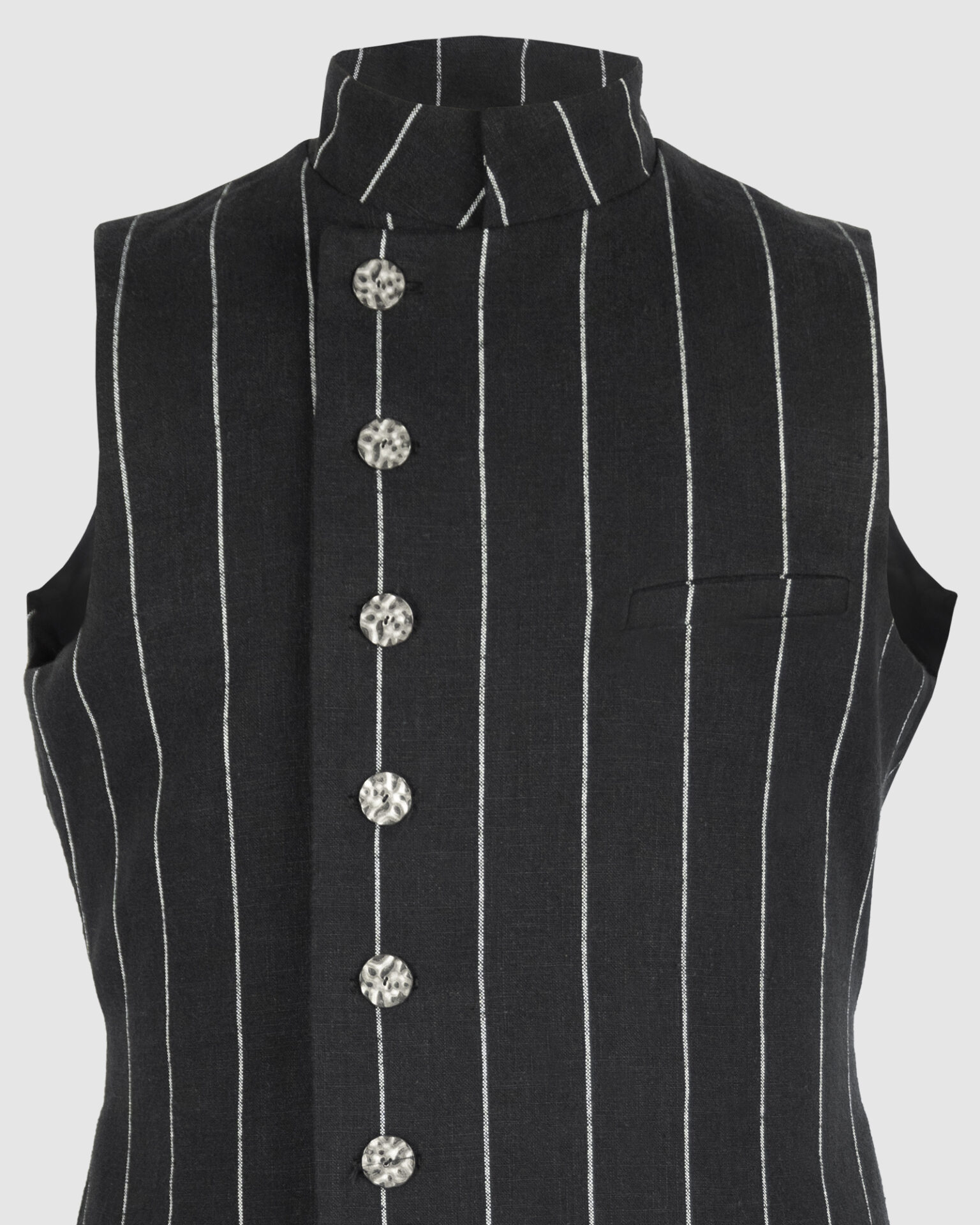 The long, fitted vest features a stand collar, a welt breast pocket, and pockets with pointed flaps.