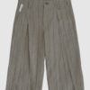 Regular rise, wide leg trousers. The front features a hidden metal button fastening, overlapping architectural pleats, and slash pockets.