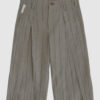 Regular rise, wide leg trousers. The front features a hidden metal button fastening, overlapping architectural pleats, and slash pockets.