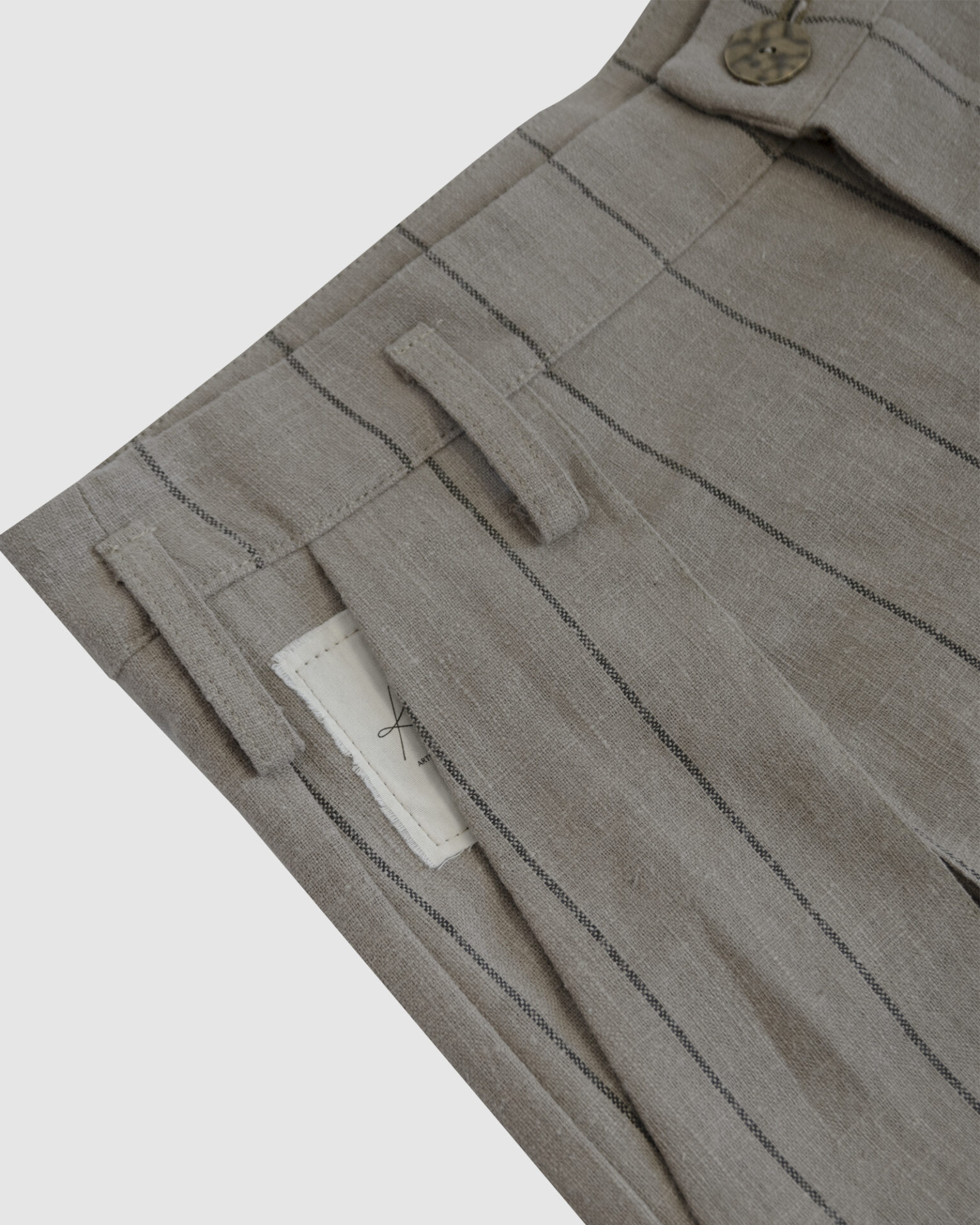 Regular rise, wide leg trousers. The front features a hidden metal button fastening, overlapping architectural pleats, and slash pockets.