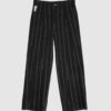 Regular rise, wide leg trousers. The front features a hidden metal button fastening, overlapping architectural pleats, and slash pockets.