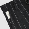 Regular rise, wide leg trousers. The front features a hidden metal button fastening, overlapping architectural pleats, and slash pockets.