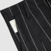 Regular rise, wide leg trousers. The front features a hidden metal button fastening, overlapping architectural pleats, and slash pockets.