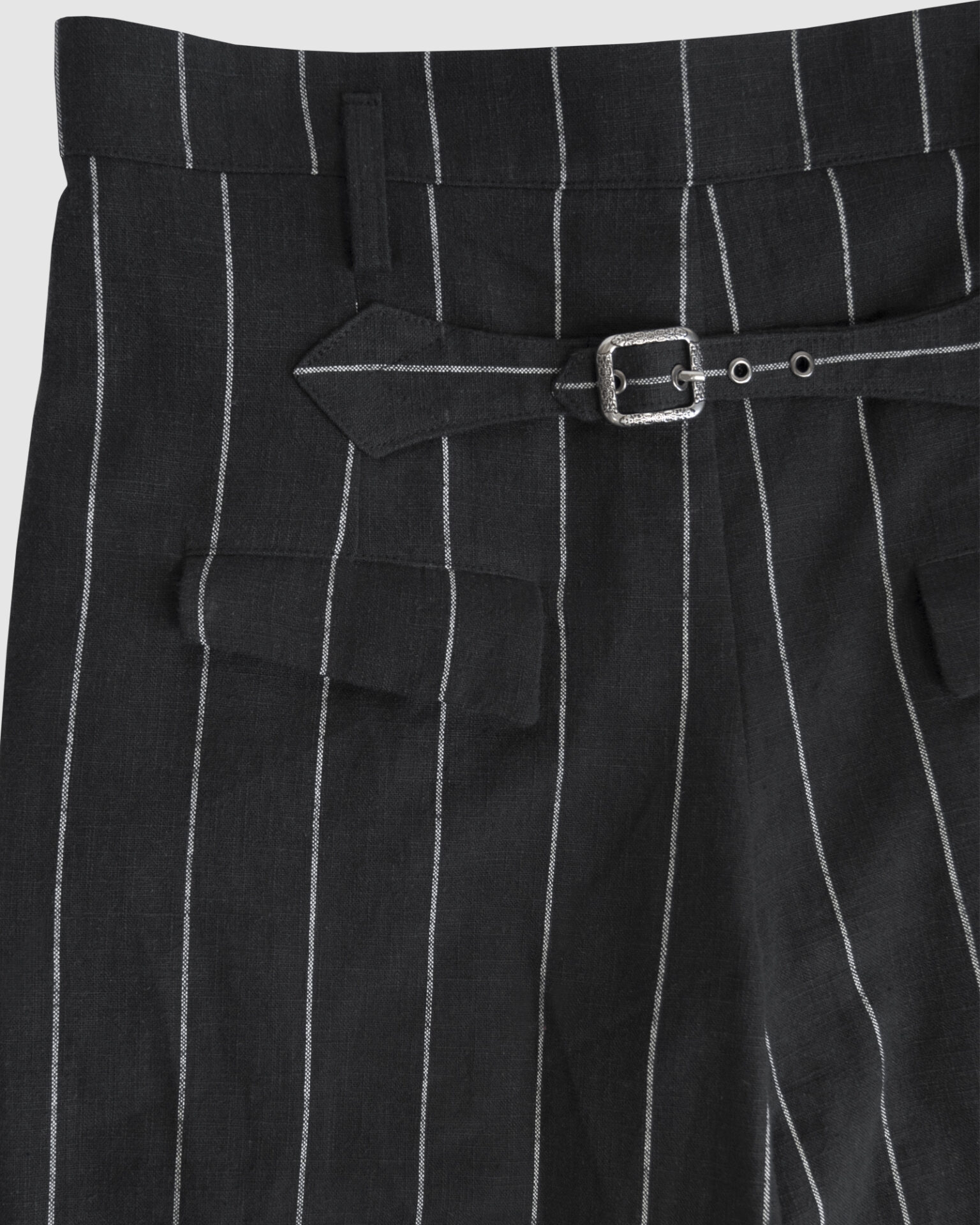 Regular rise, wide leg trousers. The front features a hidden metal button fastening, overlapping architectural pleats, and slash pockets.