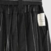 The piece is inspired by traditional Japanese hakama trousers. It is a pair of wide-legged trousers with a high waistband.