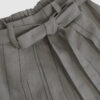 The piece is inspired by traditional Japanese hakama trousers. It is a pair of wide-legged trousers with a high waistband.