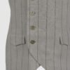 The long, fitted vest features a stand collar, a welt breast pocket, and pockets with pointed flaps.