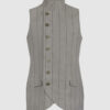 The long, fitted vest features a stand collar, a welt breast pocket, and pockets with pointed flaps.