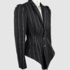 Fitted, single-breasted cotton velvet jacket with narrow peak lapels, released tucks at the waist, side seam pockets, and a softly pointed front hem.