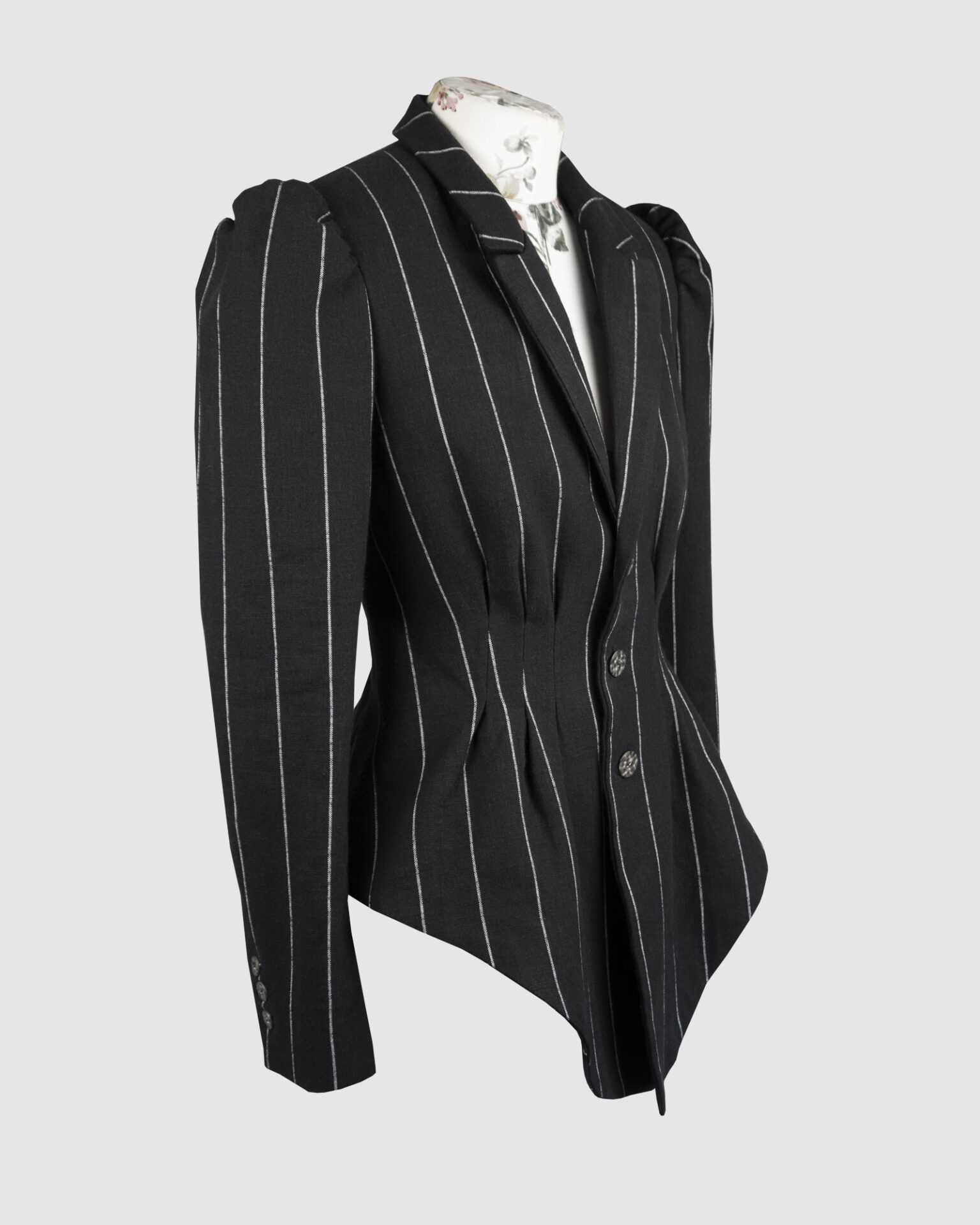 Fitted, single-breasted cotton velvet jacket with narrow peak lapels, released tucks at the waist, side seam pockets, and a softly pointed front hem.