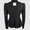 Fitted, single-breasted cotton velvet jacket with narrow peak lapels, released tucks at the waist, side seam pockets, and a softly pointed front hem.