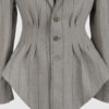Fitted, single-breasted cotton velvet jacket with narrow peak lapels, released tucks at the waist, side seam pockets, and a softly pointed front hem.