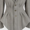 Fitted, single-breasted cotton velvet jacket with narrow peak lapels, released tucks at the waist, side seam pockets, and a softly pointed front hem.