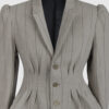 Fitted, single-breasted cotton velvet jacket with narrow peak lapels, released tucks at the waist, side seam pockets, and a softly pointed front hem.