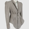 Fitted, single-breasted cotton velvet jacket with narrow peak lapels, released tucks at the waist, side seam pockets, and a softly pointed front hem.