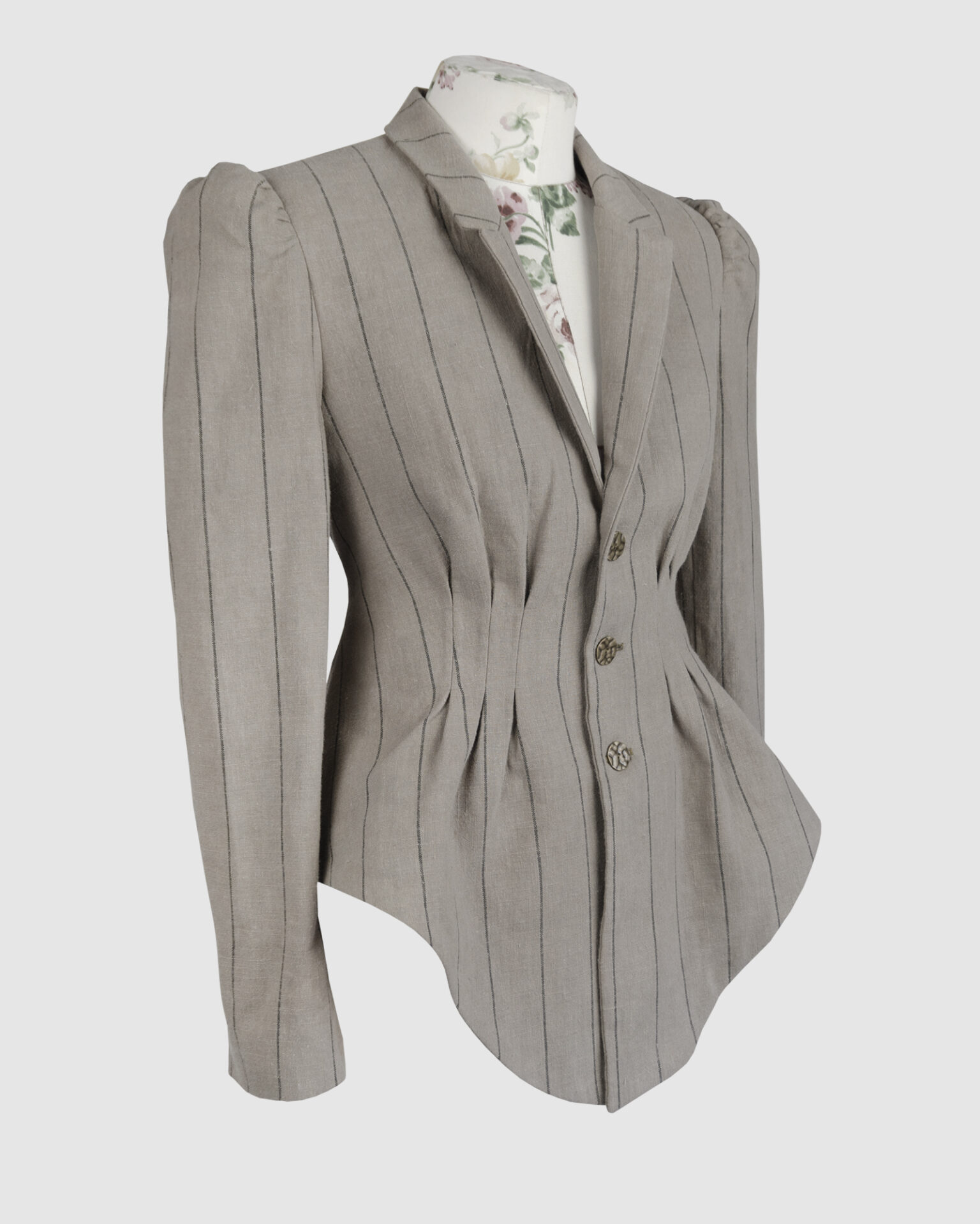 Fitted, single-breasted cotton velvet jacket with narrow peak lapels, released tucks at the waist, side seam pockets, and a softly pointed front hem.