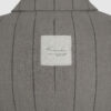 Semi-fitted double-breasted jacket with peak lapels, a welt breast pocket, and pockets with asymmetrical flaps. Designed in a 4x1 configuration