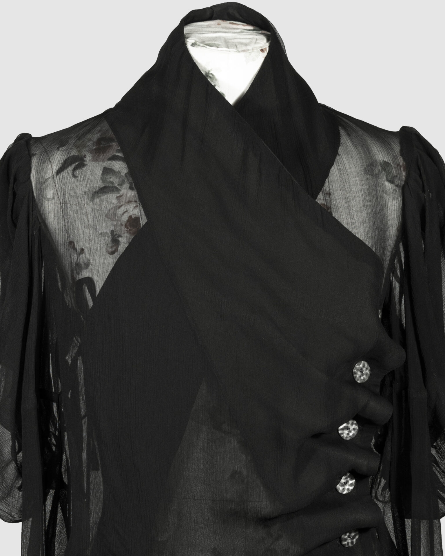 Fitted blouse with a draped front and voluminous sleeves