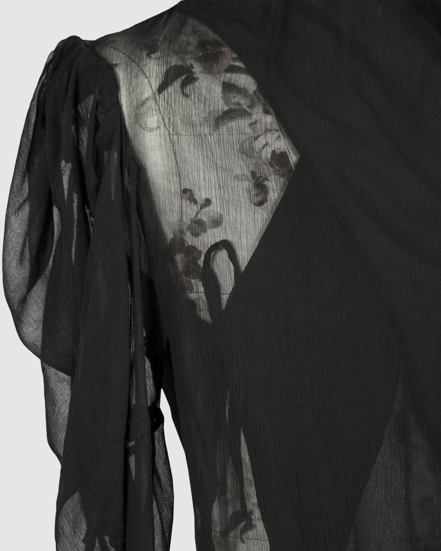 Fitted blouse with a draped front and voluminous sleeves