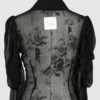 Fitted blouse with a draped front and voluminous sleeves