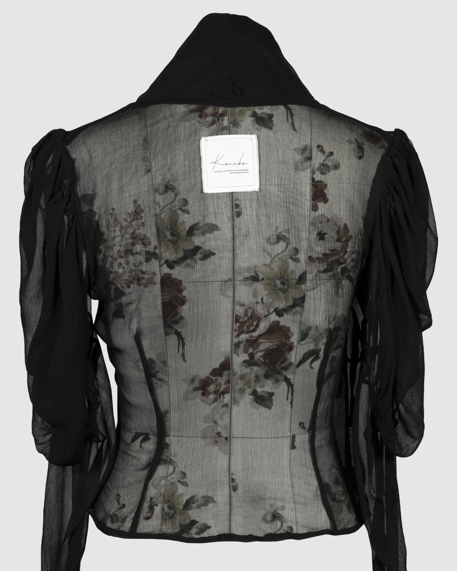 Fitted blouse with a draped front and voluminous sleeves