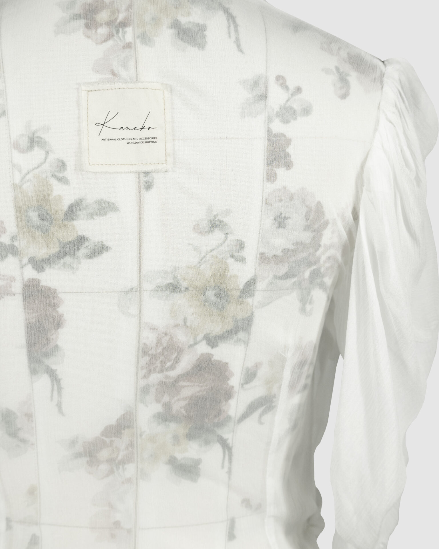 Fitted blouse with a draped front and voluminous sleeves