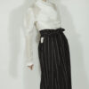 Fitted blouse with a draped front and voluminous sleeves The piece is inspired by traditional Japanese hakama trousers. It is a pair of wide-legged trousers with a high waistband.