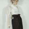 Fitted blouse with a draped front and voluminous sleeves The piece is inspired by traditional Japanese hakama trousers. It is a pair of wide-legged trousers with a high waistband.