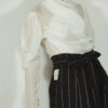 Fitted blouse with a draped front and voluminous sleeves The piece is inspired by traditional Japanese hakama trousers. It is a pair of wide-legged trousers with a high waistband.