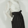 Fitted blouse with a draped front and voluminous sleeves The piece is inspired by traditional Japanese hakama trousers. It is a pair of wide-legged trousers with a high waistband.