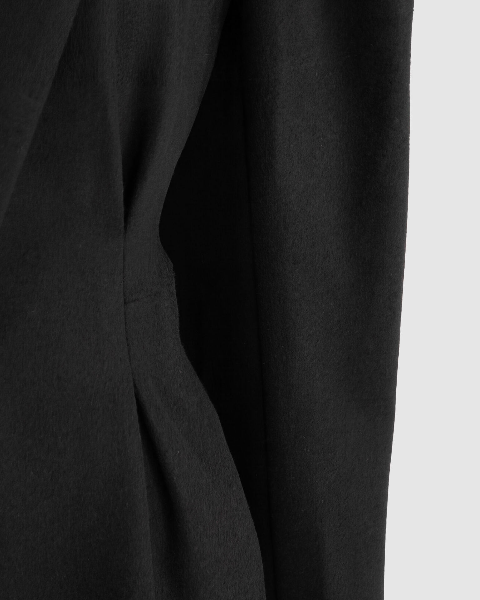 Coat with draped sleeves